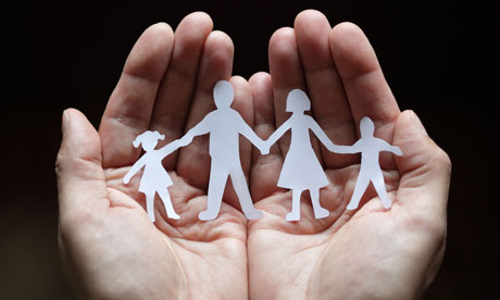 Paper chain family protected in cupped hands